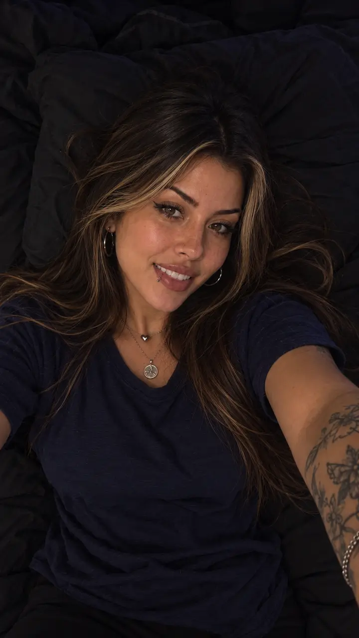 Juuh sorrindo deitada na cama